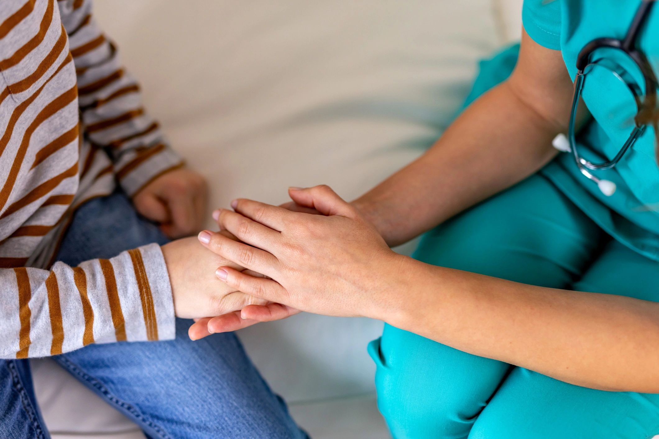 Two people holding hands in support