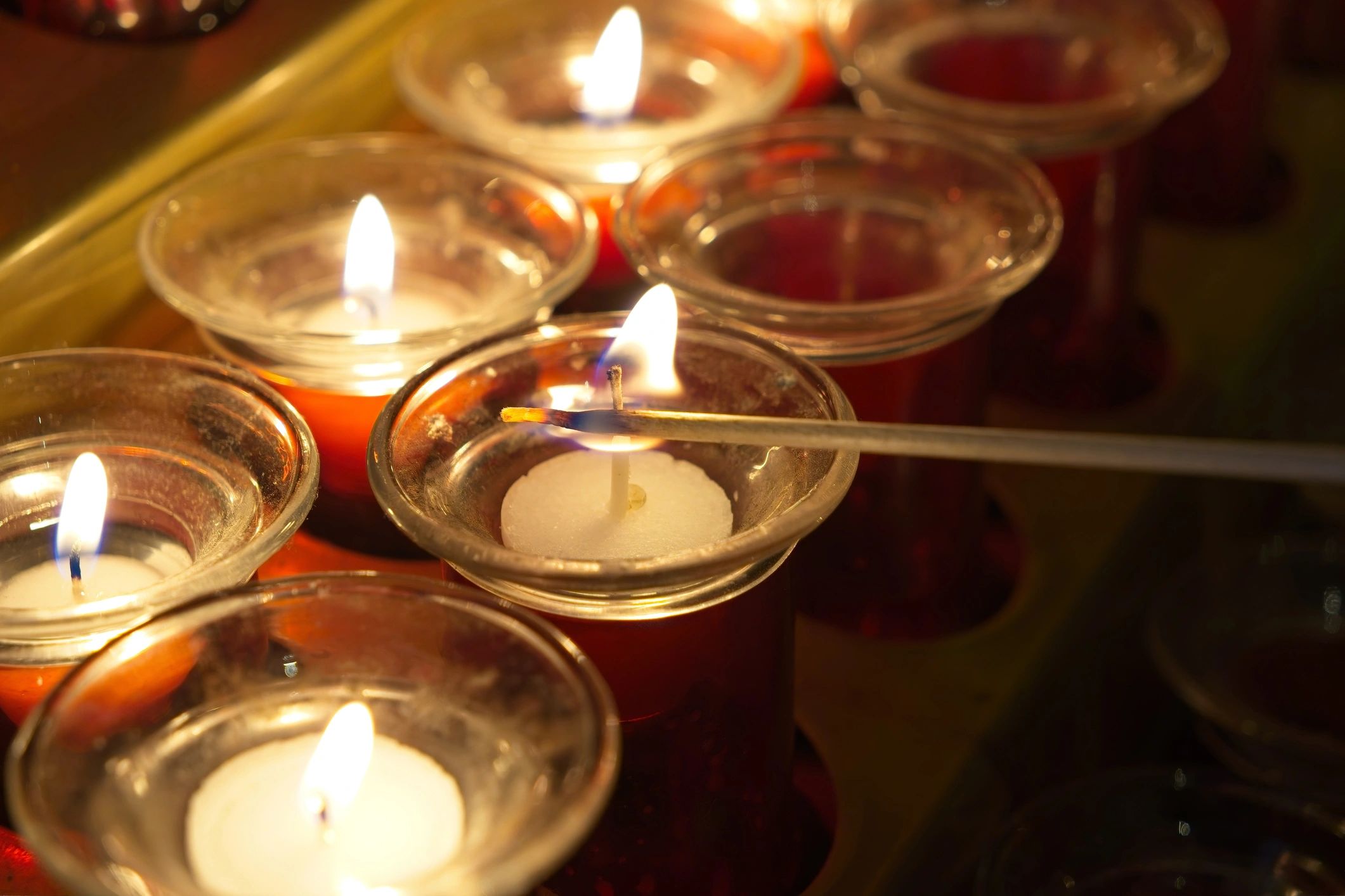 Person lighting a memorial candle