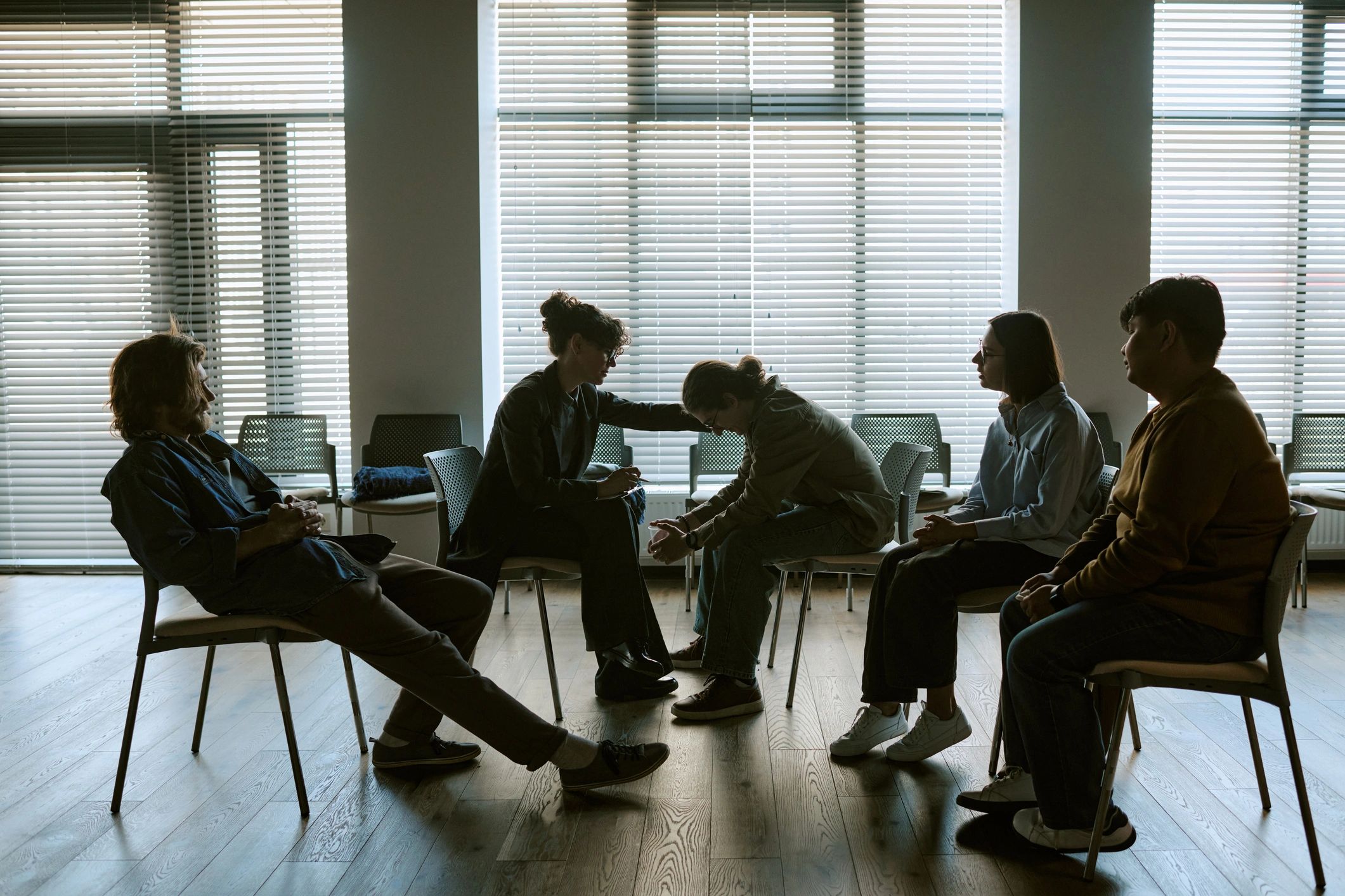 Adults gathered in a grief support group session