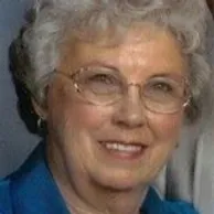 Portrait of La Rita Archibald smiling in a blue top