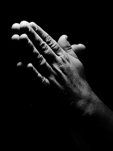 Black-and-white close-up of a hand against a dark background for the Saddleback Church section