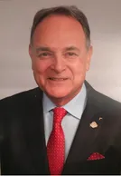 Portrait of Rufus Tamayo in a dark suit with a red tie and red pocket square