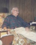Portrait of an older man seated indoors