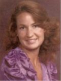Portrait of a smiling woman in a purple top