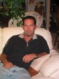 Portrait of a seated man on a couch