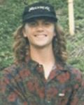 Portrait of a smiling person outdoors in a cap