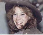Portrait of a smiling woman in a dark hat